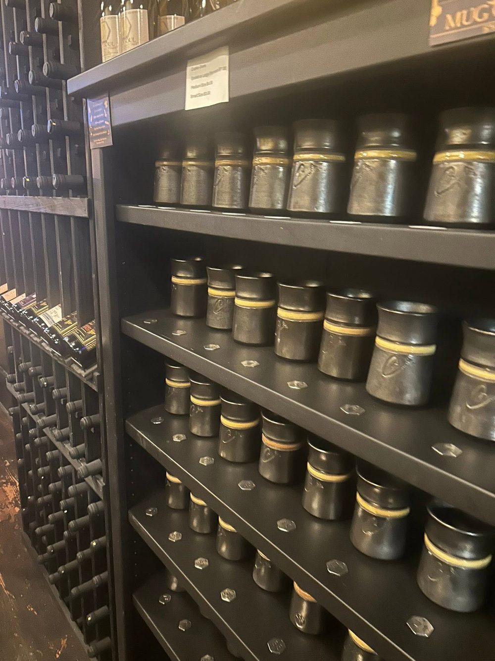 Handmade mugs and wine racks inside the tasting room